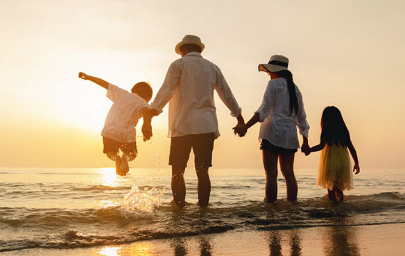 Family on a beach at sunset